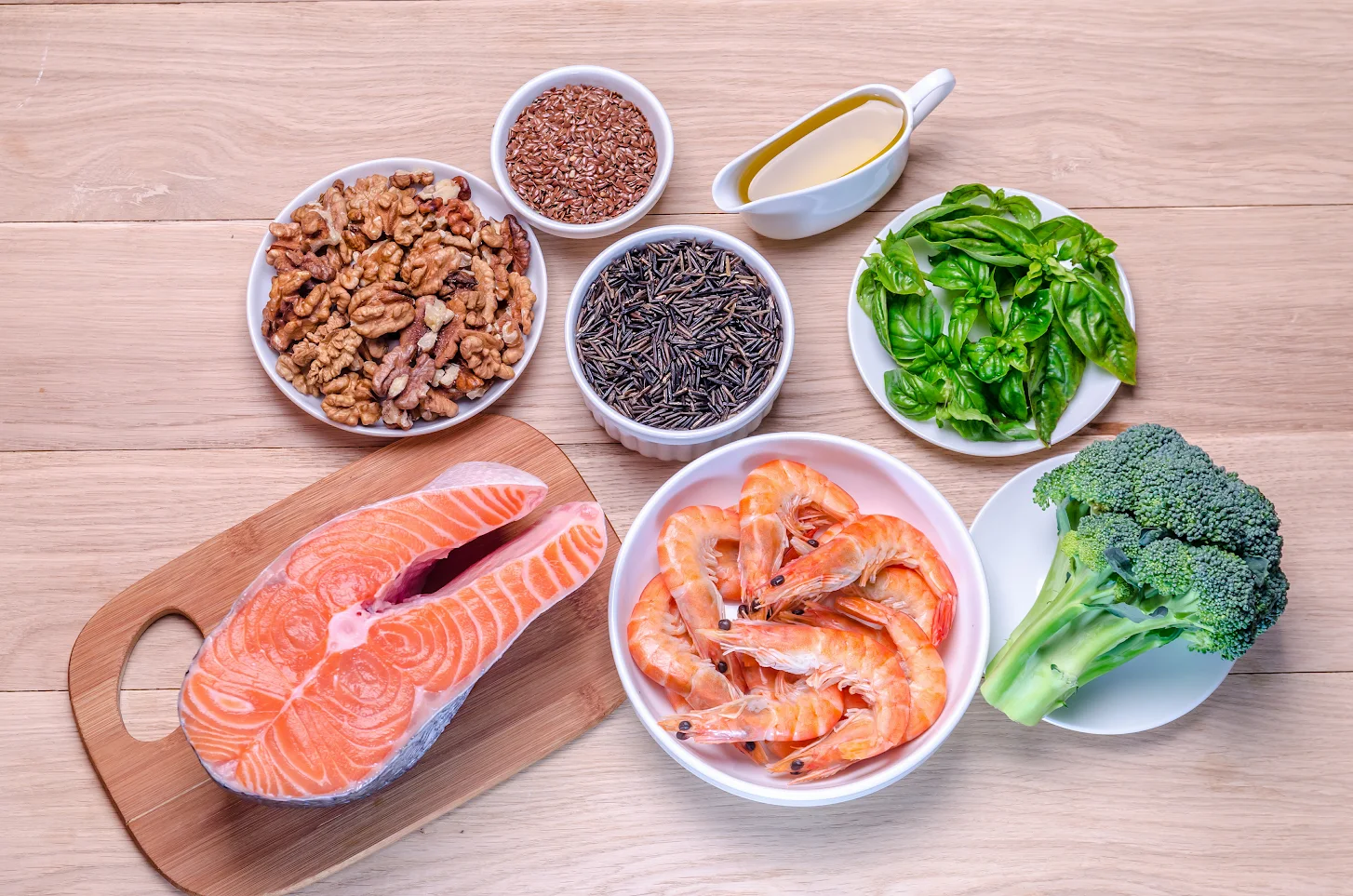 Omega-3 food sources including salmon, walnuts and flaxseed, covering both ALA and EPA/DHA